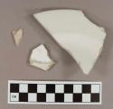 Undecorated white porcelain vessel base and body fragments