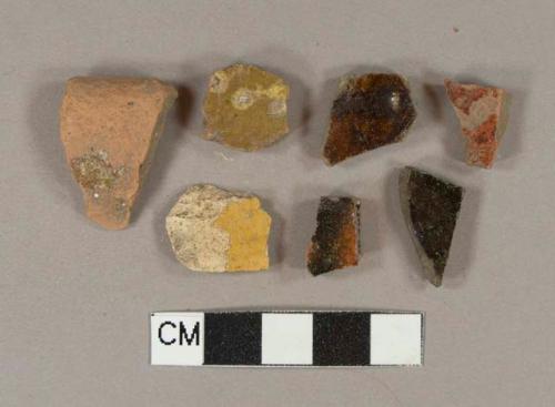 Brown, black, and yellow slip glazed earthenware vessel body fragments, 13 red paste, 6 buff paste, 2 gray paste