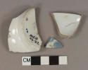 White pearlware vessel body and base fragments, white paste, 1 blue transferprinted fragment, 1 with remnant of blue stamp