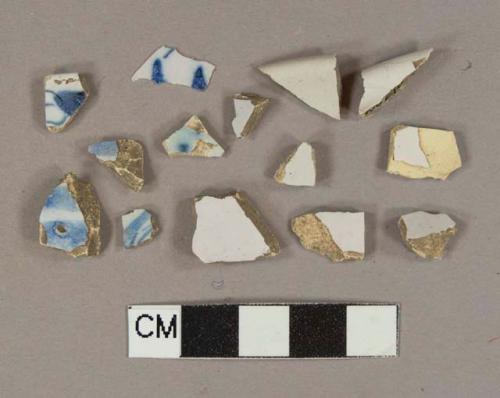 White tin-glazed earthenware vessel body and rim fragments, buff paste, 6 blue handpainted fragments