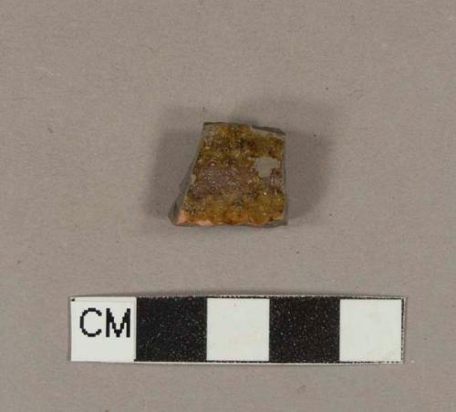 Undecorated, lead glazed, burned redware body sherd