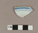 Blue hand painted porcelain rim sherd with brown glaze on top of rim