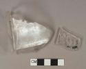 Colorless glass bottle body fragments, 1 fragment with molded lettering "[...]HAR[...] / [...]E, MA[...]" , 1 fragment with molded lettering "M.B.W. / M[...]"
