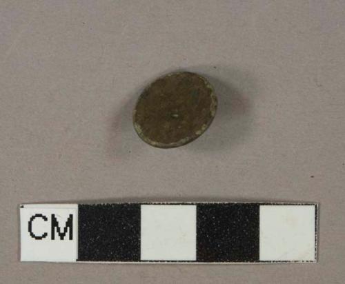Undecorated brass button with intact shank