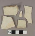 Undecorated whiteware body sherds; two sherds crossmend