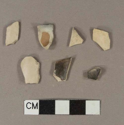 Smoked, undecorated pipe bowl fragments; two fragments crossmend; two fragments crossmend; two fragments crossmend