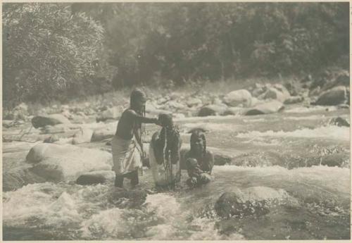 Tinguian women bathing in stream