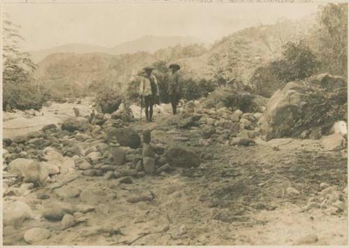 Tinguian men of Daguioman standing near possible rock shrine