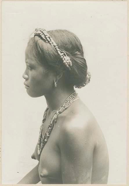 Tinguian woman wearing typical ornaments and dress, profile