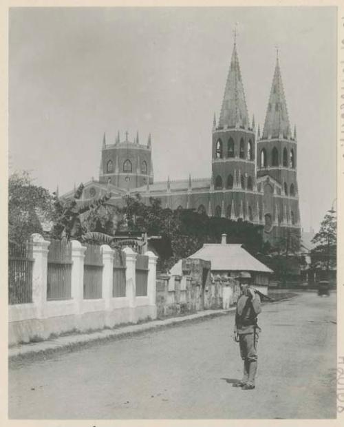 San Sabastian church behind man holding gun