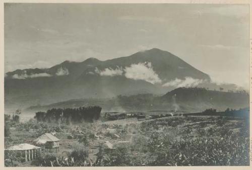 Canlaon Volcano, with buildings and fields in foreground