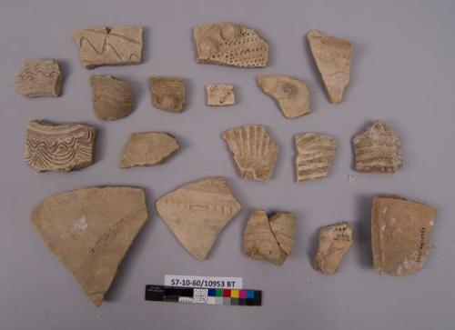 19 potsherds - bisque and greenish paste; decorated;