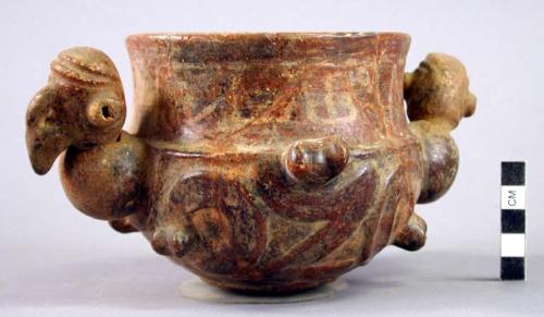 Vessel with 2 moveable bird heads