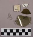 3 plates; 1 large metal ring; bone; copper tubing; glass fragments