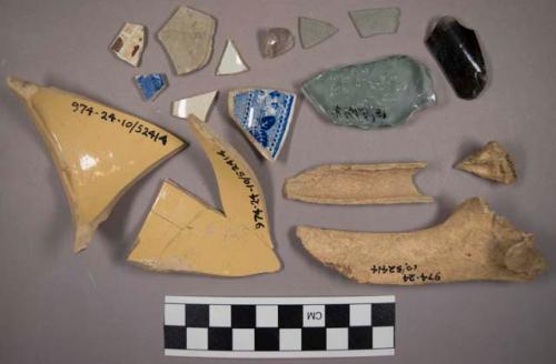 Earthenware rim sherds, bone, nails, and glass