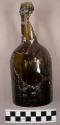Glass bottle, brown, mended