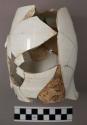 Whitewashed window pane, pitchers (white china), bottle fragments
