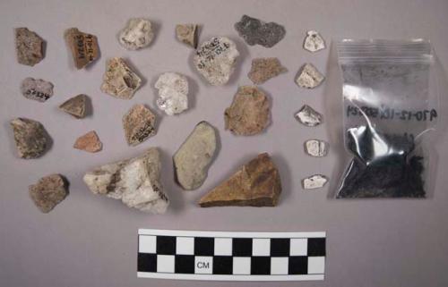 Approx. 60 stone chips (some shale); 34 pieces of quartz; charred bone; charcoal