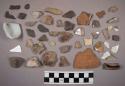 16 glazed potsherds; fragment of glass; fragment of milk glass; approx 35 stone