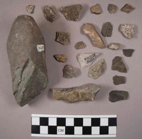 45 stone flakes and chips; 1 worked stone flake (?); 1 large smooth-ended stone