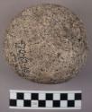 Large spherical, battered stone