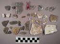 15 stone chips, 5 fragments of glass; glass bottle neck; nail; 9 glazed ceramic