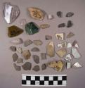 12 glazed ceramic sherds; 3 glass fragments; 20 stone chips; 2 pieces of bone