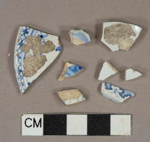 Blue on white transferprinted lead glazed earthenware vessel body and rim fragments, light buff paste