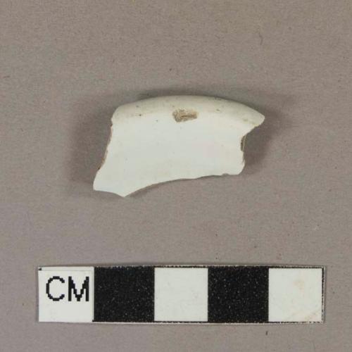 Undecorated whiteware rim sherd; could also possibly be a base sherd