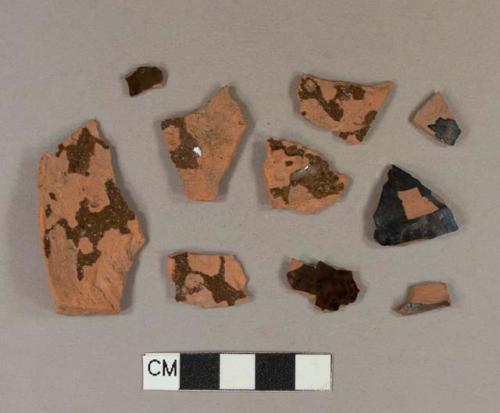 Undecorated lead glazed redware body sherds; two sherds crossmend