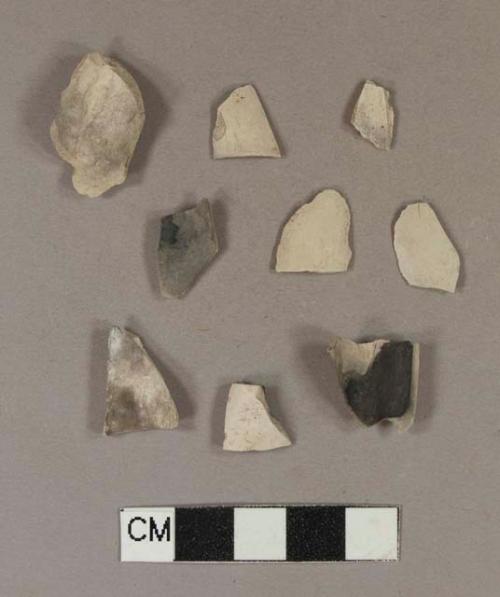 Smoked, undecorated pipe bowl fragments; two fragments crossmend; two fragments crossmend