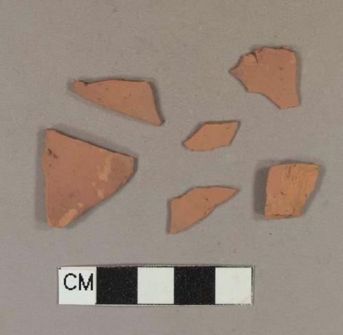 Unglazed, undecorated redware body sherds; two sherds crossmend