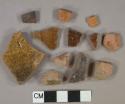 Brown and yellow slip-glazed redware vessel body fragments