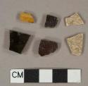 Black and yellow slip-glazed earthenware vessel body fragments, buff paste, 1 fragment gray paste, likely jackfield type