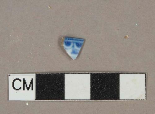 Blue on white transferprinted earthenware vessel rim fragment, buff paste