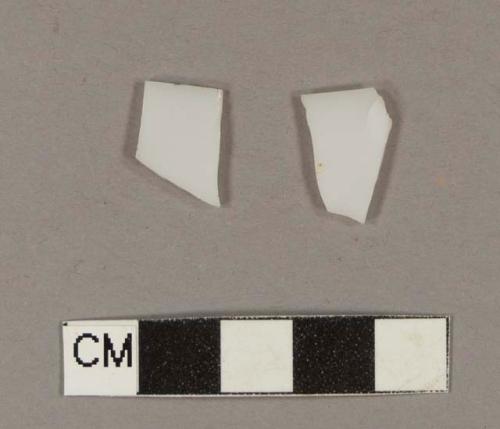 Milk white bottle glass fragments; two fragments crossmend