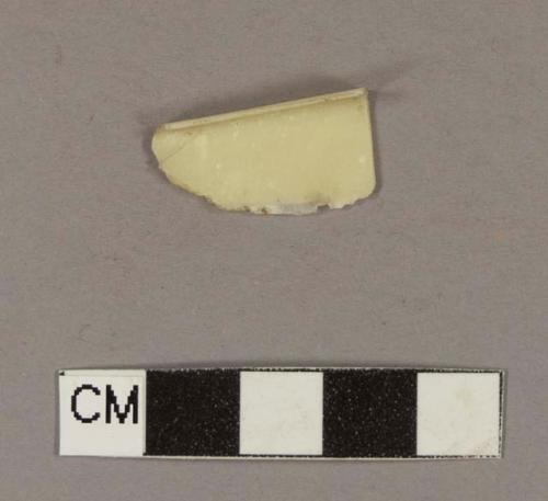 Cream colored plastic fragment