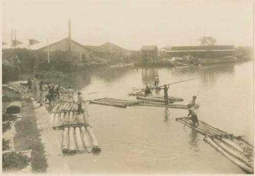 Rafts of logs being poled to sawmill