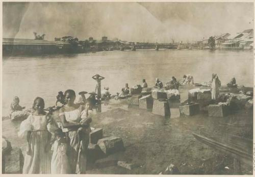 Women doing laundry along Pasig River