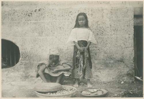 Girls selling Chicos fruit and cooked food