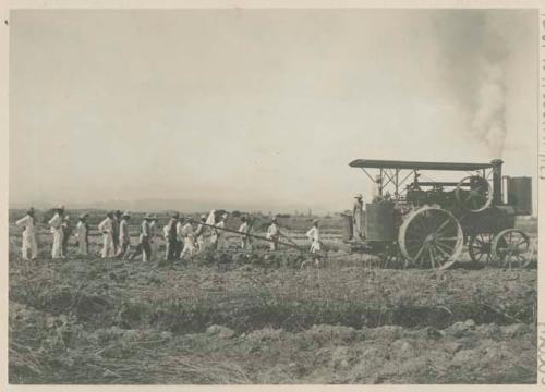 Filipino men with steam plow on Government Rice Farm