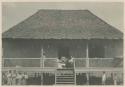 Women and children in front of house of Overseer, Government Rice Farm