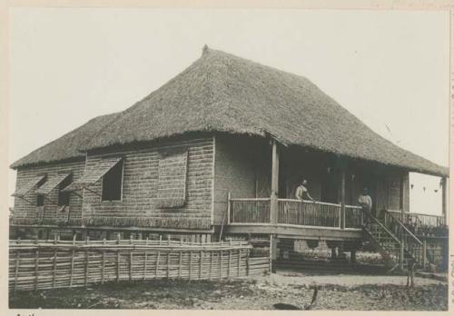 Two men in front of house of Overseer, Government Rice Farm