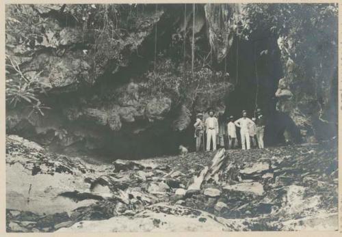 Group of men standing in entrance to Puning Cave, Bulacan