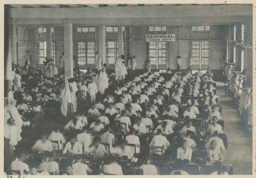 People making cigars by hand at the "Germinal" factory