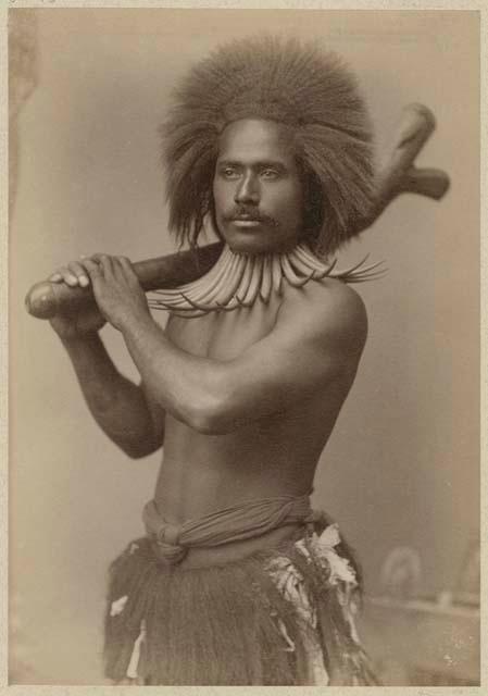 Studio staged portrait of man with club