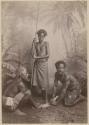 Studio staged portrait of three men making a fire