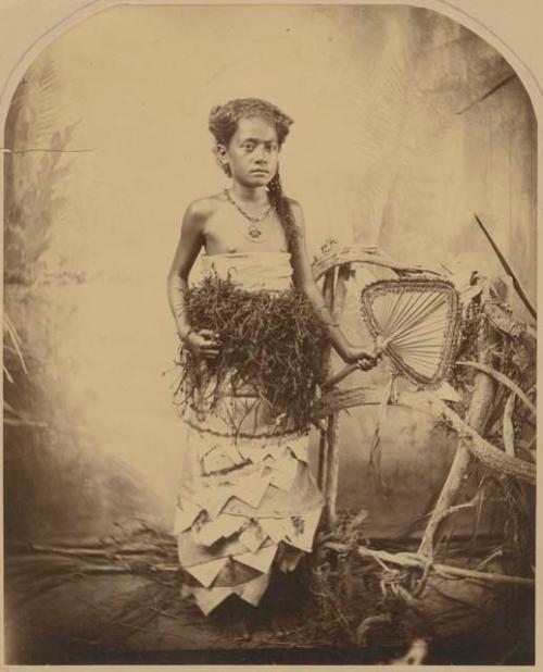 Studio staged portrait of Adi [Cakobau] as a child holding a fan