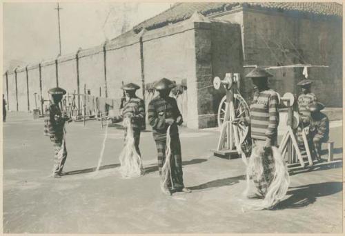 Prisoners making hemp ropes, twisting fibers