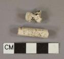 White undecorated kaoline pipe fragments, 1 foot fragment, 1 incised stem fragment with 6/64" bore diameter